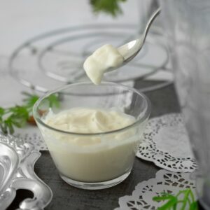 close-up photo of white cream in clear shot glass